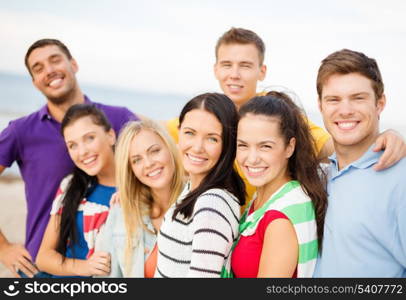 summer, holidays, vacation and happiness concept - group of friends having fun on the beach