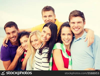 summer, holidays, vacation and happiness concept - group of friends having fun on the beach