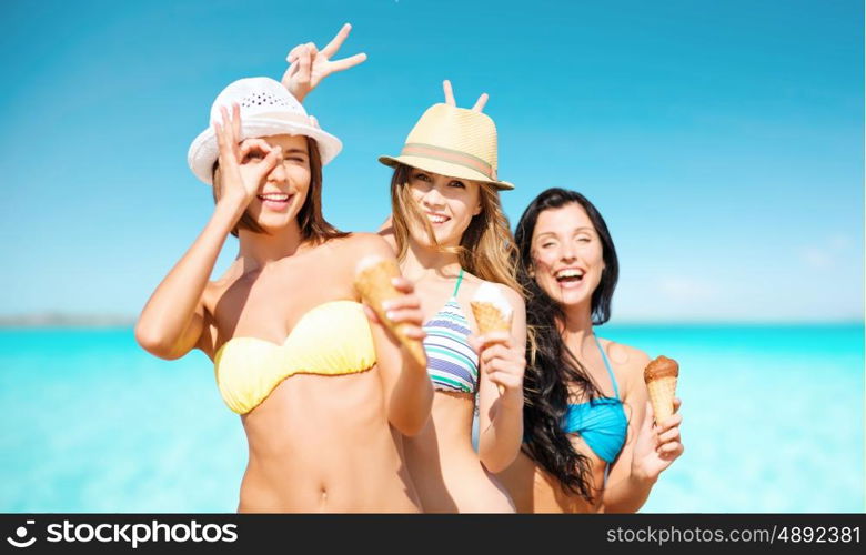 summer holidays, vacation, food, travel and people concept - group of smiling young women in hats eating ice cream over sea and blue sky background