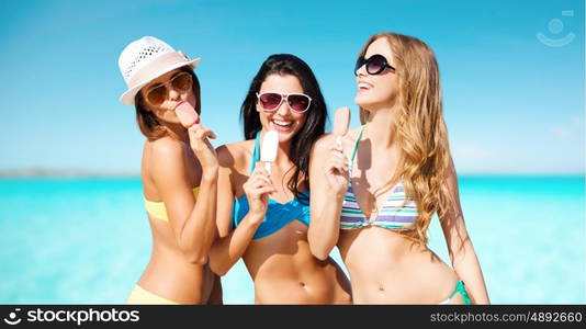 summer holidays, vacation, food, travel and people concept - group of smiling young women eating ice cream on beach over sea and blue sky background