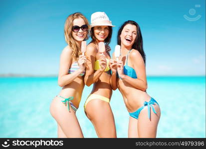 summer holidays, vacation, food, travel and people concept - group of smiling young women eating ice cream on beach over sea and blue sky background. group of smiling women eating ice cream on beach