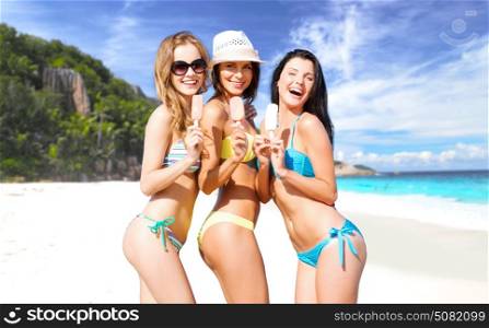 summer holidays, vacation, food, travel and people concept - group of smiling young women eating ice cream over exotic tropical beach background. group of smiling women eating ice cream on beach