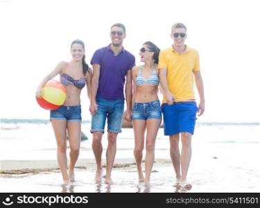summer, holidays, vacation, happy people concept - group of friends having fun playing with ball on the beach
