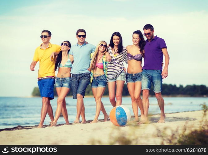 summer, holidays, vacation, happy people concept - group of friends having fun with ball on the beach