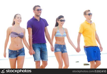 summer, holidays, vacation, happy people concept - group of friends having fun on the beach