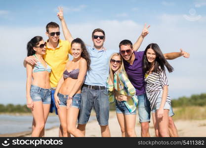 summer, holidays, vacation, happy people concept - group of friends having fun on the beach