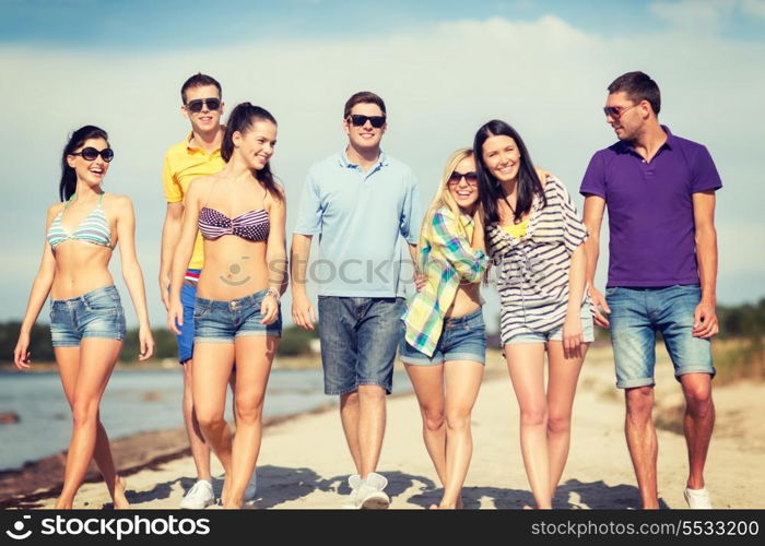 summer, holidays, vacation, happy people concept - group of friends having fun on the beach