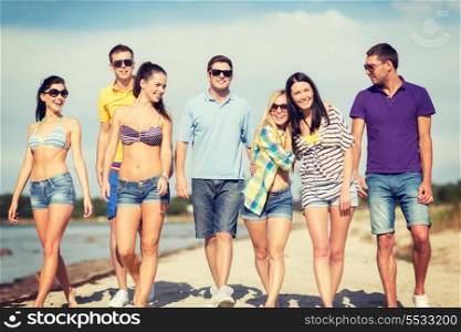 summer, holidays, vacation, happy people concept - group of friends having fun on the beach