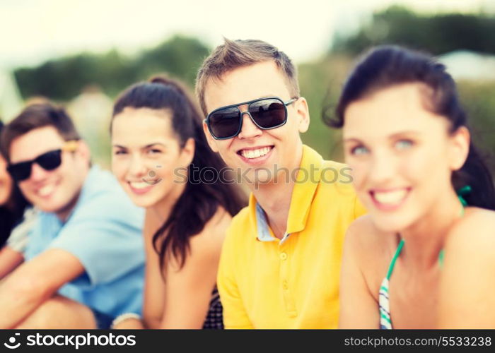 summer, holidays, vacation, happy people concept - group of friends having fun on the beach