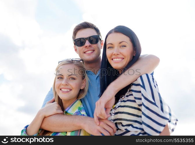 summer, holidays, vacation, happy people concept - group of friends having fun on the beach