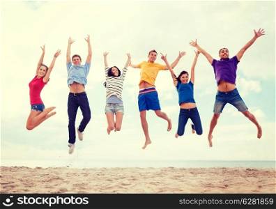 summer, holidays, vacation, happy people concept - group of friends jumping on the beach