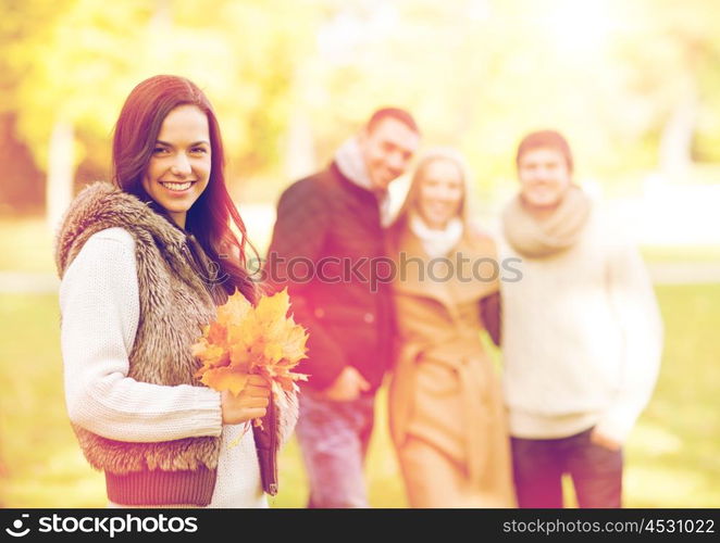 summer, holidays, vacation, happy people concept - group of friends or couples having fun in autumn park