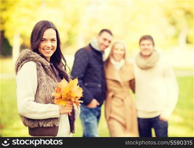 summer, holidays, vacation, happy people concept - group of friends or couples having fun in autumn park
