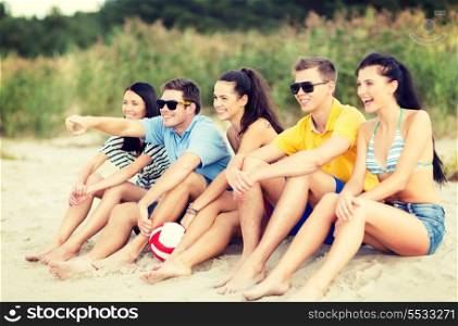 summer, holidays, vacation, happy people concept - group of friends or volleyball team having fun on the beach