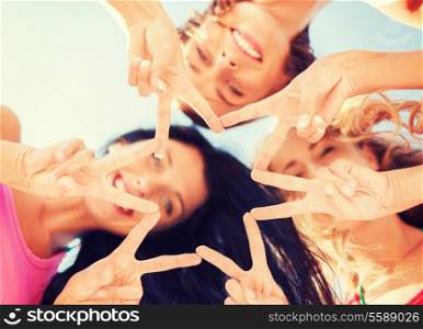 summer, holidays, vacation, happy people concept - group of girls looking down and showing finger five gesture