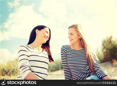 summer, holidays, vacation, happy people concept - smiling girlfriends having fun on the beach