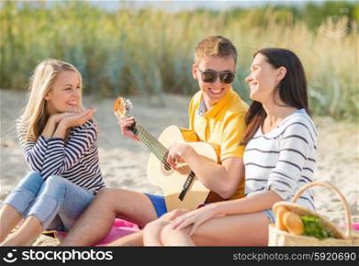 summer holidays, vacation, music, happy people concept - group of happy friends playing guitar on beach