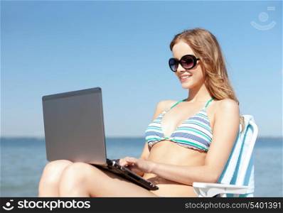summer holidays, vacation, technology and internet - girl looking at tablet pc on the beach chair