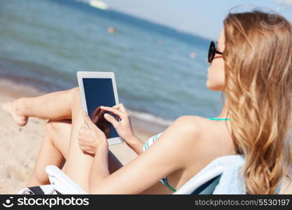 summer holidays, vacation, technology and internet - girl looking at tablet pc on the beach chair