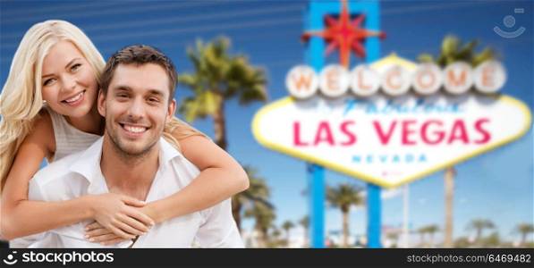 summer holidays, vacation, tourism and travel concept - happy couple in shades over welcome to fabulous las vegas sign background. couple in shades over las vegas sign at summer