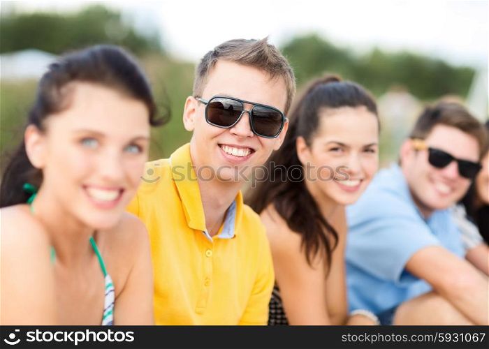 summer holidays, vacation, tourism, travel and people concept - group of happy friends on beach