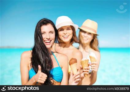 summer holidays, vacation, travel and people concept - group of smiling young women with ice cream showing thumbs up on beach over sea and blue sky background. group of happy young women with ice cream on beach