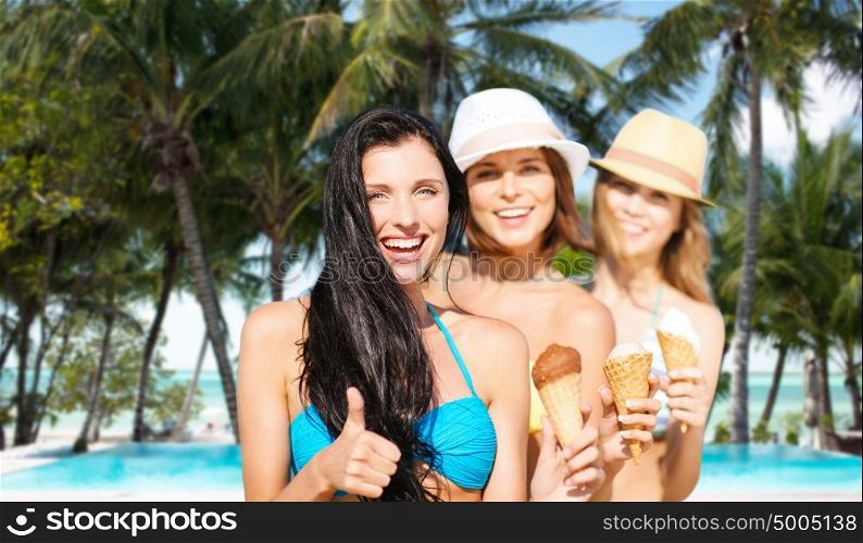 summer holidays, vacation, travel and people concept - group of smiling young women with ice cream showing thumbs up over exotic tropical beach with palm trees and pool background. group of happy young women with ice cream on beach