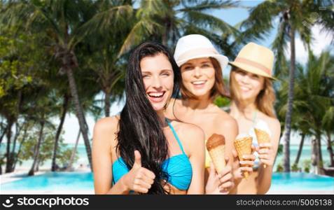 summer holidays, vacation, travel and people concept - group of smiling young women with ice cream showing thumbs up over exotic tropical beach with palm trees and pool background. group of happy young women with ice cream on beach