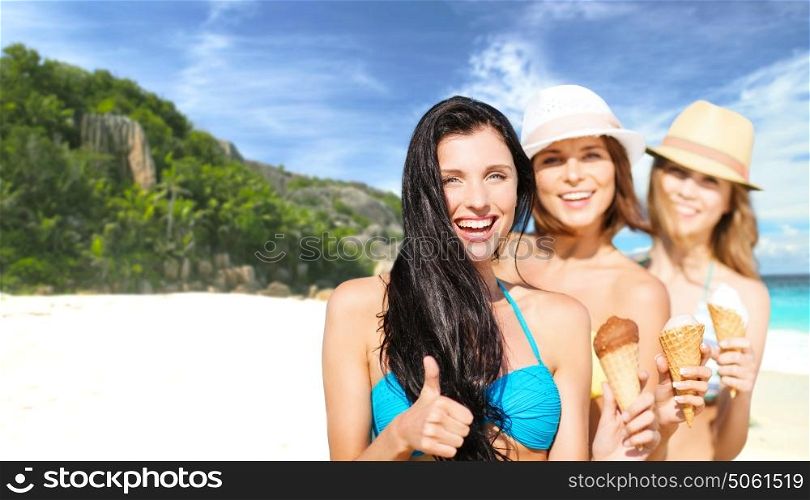 summer holidays, vacation, travel and people concept - group of smiling young women with ice cream showing thumbs up over exotic tropical beach background. group of happy young women with ice cream on beach