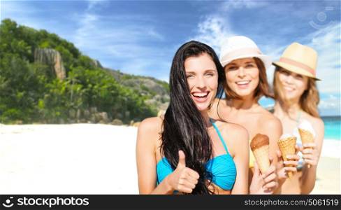 summer holidays, vacation, travel and people concept - group of smiling young women with ice cream showing thumbs up over exotic tropical beach background. group of happy young women with ice cream on beach