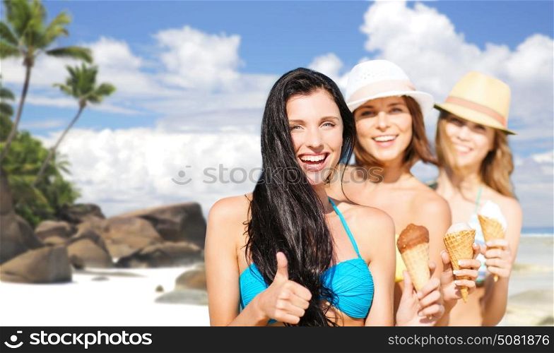 summer holidays, vacation, travel and people concept - group of smiling young women with ice cream showing thumbs up over exotic tropical beach and palm trees background. group of happy young women with ice cream on beach