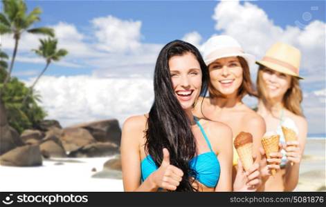 summer holidays, vacation, travel and people concept - group of smiling young women with ice cream showing thumbs up over exotic tropical beach and palm trees background. group of happy young women with ice cream on beach