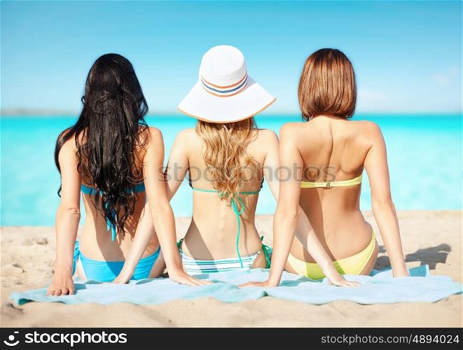 summer holidays, vacation, travel and people concept - group of women in swimwear sunbathing over exotic tropical beach background