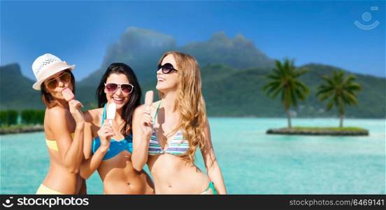 summer holidays, vacation, travel and tourism concept - group of smiling young women eating ice cream at touristic resort over exotic bora bora island beach background. group of smiling women eating ice cream on beach