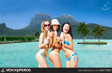 summer holidays, vacation, travel and tourism concept - group of smiling young women eating ice cream at touristic resort over exotic bora bora island beach background. group of smiling women eating ice cream on beach. group of smiling women eating ice cream on beach