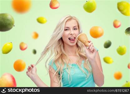summer, junk food and people concept - young woman in sunglasses eating ice cream over green natural background with fruits
