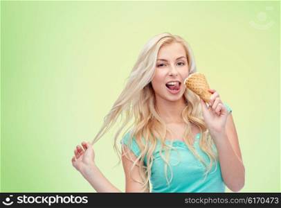 summer, junk food and people concept - young woman in sunglasses eating ice cream over green natural background