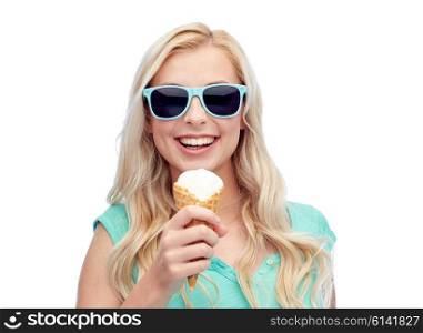 summer, junk food and people concept - young woman or teenage girl in sunglasses eating ice cream