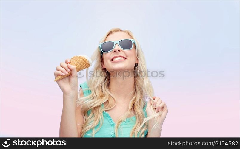 summer, junk food and people concept - young woman or teenage girl in sunglasses eating ice cream over rose quartz and serenity gradient background