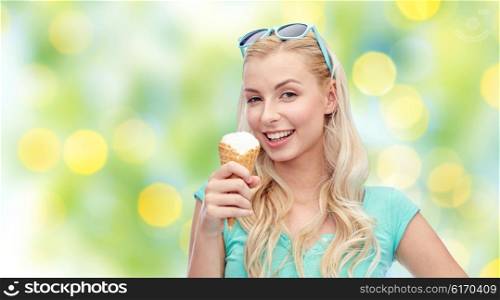 summer, junk food and people concept - young woman or teenage girl in sunglasses eating ice cream over green lights background