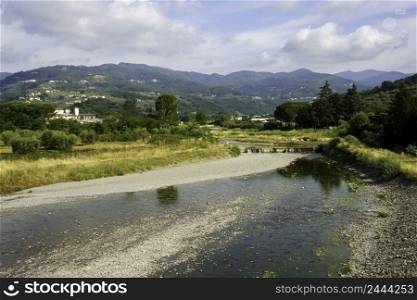 Summer landscape along river near Pistoia, Tuscany, Italy