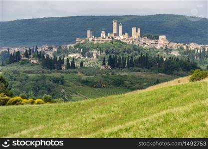 Summer landscape in the Chianti region near Poggibonsi, Siena, Tuscany, Italy with San Gimignano in background