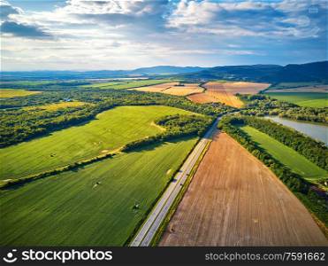 Summer landscape with fields, meadows, lake and mountains. Road on the lakeside. Aerial view of Storage reservoir Zemplinska Sirava, largest lake in Slovakia, near Michalovce town