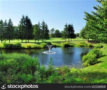 summer landscape with pond and golf course