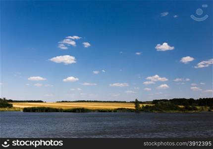 Summer landscape with river and cloudy sky