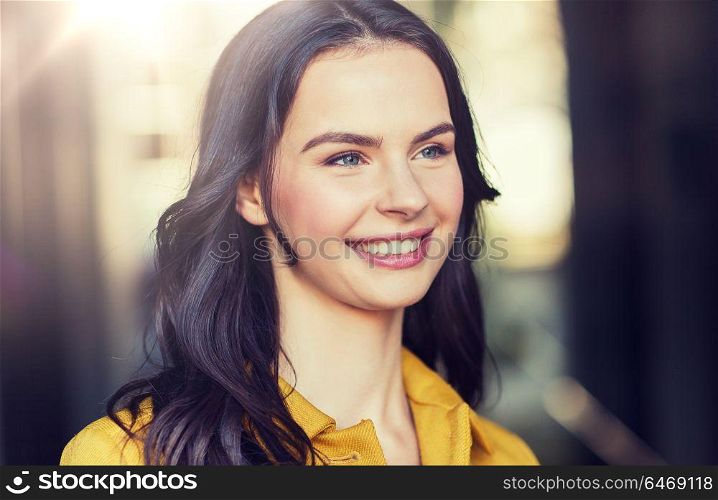 summer, leisure, vacation and people concept - smiling young woman in city. smiling young woman in city