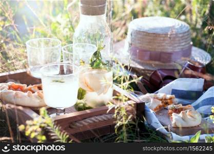 Summer - lemonade with lemon and mint with apricot biscuit and a basket