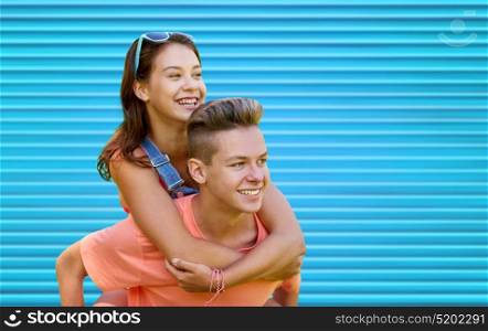 summer, love and people concept - happy smiling teenage couple having fun over blue ribbed background. happy teenage couple having fun over blue