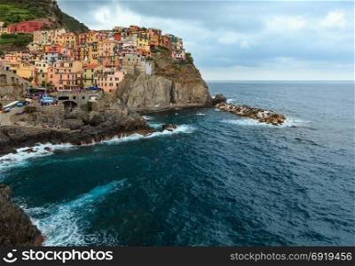Summer Manarola - one of five famous villages of Cinque Terre National Park in Liguria, Italy, suspended between sea and land on sheer cliffs. People unrecognizable.
