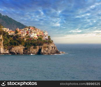 Summer Manarola view from Corniglia village. This is a famous villages of Cinque Terre National Park in Liguria, Italy, suspended between sea and land on sheer cliffs. People unrecognizable.